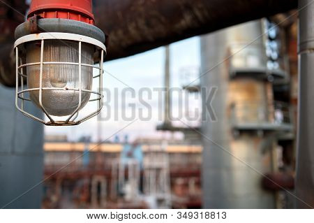 Lighting Mast With Lantern In Explosion-proof And Fire-proof Design Close-up Over Background Of Pipe