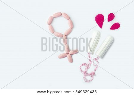 Protective Menstrual Cotton Tampons And Gender Symbol Made From Pink Pain Pills. The Concept Of Wome