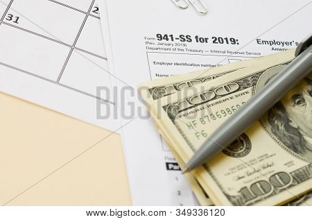 Irs Form 941-ss Employers Quarterly Federal Tax Return Blank Lies With Pen And Many Hundred Dollar B