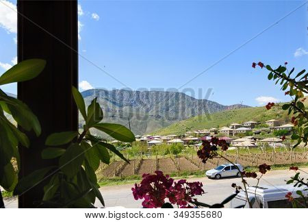 Winery Mountain Village Of Areni In Armenia. View Through Window With Indoor Flowers Out Of Focus