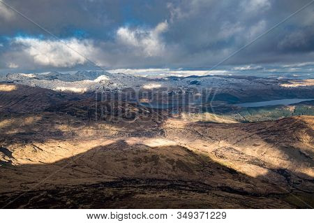 Dramatic Winter View From Ben Lomond Towards Loch Lomond And The Peaks Of Arrochar Alps In Scottish 