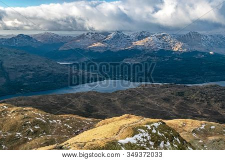 Loch Lomond And The Peaks Of Arrochar Alps On A Winter Afternoon Seen From Ben Lomond. Scottish High