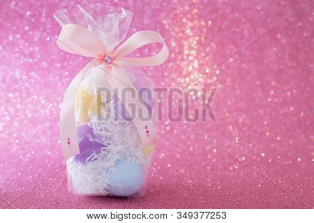Multi-colored Purple, Pink, Blue, Yellow Easter Eggs In A Transparent Gift Package, Decorated With A