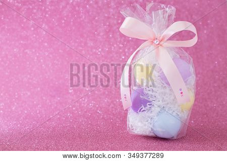 Multi-colored Purple, Pink, Blue, Yellow Easter Eggs In A Transparent Gift Package, Decorated With A