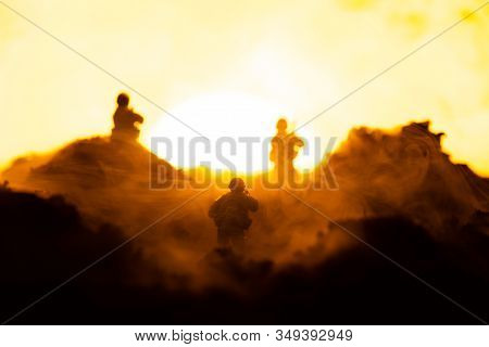 Selective Focus Of Toy Warriors On Battleground With Sunset At Background, Battle Scene