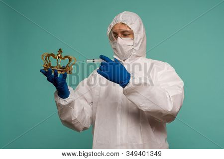 A Male Doctor In Protective Overalls And A Mask Makes An Injection In The Crown. Coronovirus Protect