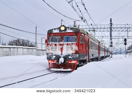 Perm, Russia - February 01, 2020: Ice Covered Passenger Electric Multiple-unit Train At Winter Railw