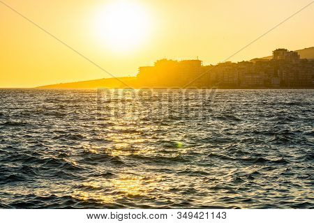 Orange Sunset Above Mediterranean Sea By The City Sarande In Albania