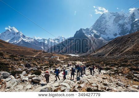 Large Expedition Members Grouon Everest Base Camp Trekking Route Near Dughla 4620m. Backpackers Usin