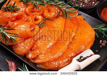 Raw marinated chicken legs for grill and bbq.Chicken legs in a red marinade on a cooking board. Pickled raw meat. Dietary meat. Cooking.Sottilissime