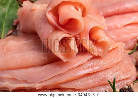 Raw sliced chicken meat close-up. Sotilissimo. Delicious dietary meat. Cooking,food of meat and fillets.Close-up view of raw, fresh, choped and sliced chicken meat.Sottilissime