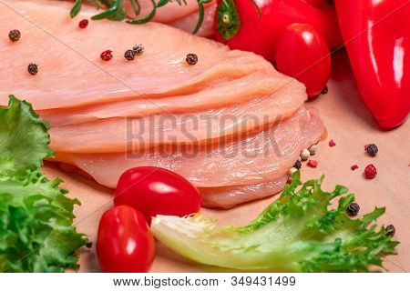 Raw sliced chicken meat close-up. Sotilissimo. Delicious dietary meat. Cooking,food of meat and fillets.Close-up view of raw, fresh, choped and sliced chicken meat.Sottilissime.