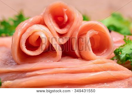 Raw sliced chicken meat close-up. Sotilissimo. Delicious dietary meat. Cooking,food of meat and fillets.Close-up view of raw, fresh, choped and sliced chicken meat.Sottilissime.