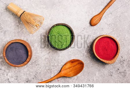 Different Colors Of Japanese Matcha Tea: Green, Red And Blue In Wooden Bowls On Gray Background. Aca