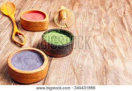 Different Colors Of Japanese Matcha Tea: Green, Red And Blue In Wooden Bowls On Wooden Background. A