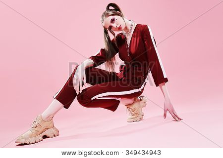 Fashion concept. Sport chic style. Full length portrait of a pretty girl in fashionable sportswear.