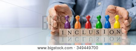 Man Protecting Inclusion Text  And Multi Colored Pawns