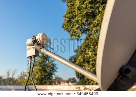Lnb, Satellite Dish Over The Blue Sky In Background, Selective Focus.