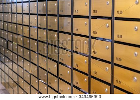 Metallic Mailbox Rows At Postal Room Inside Condominium Building