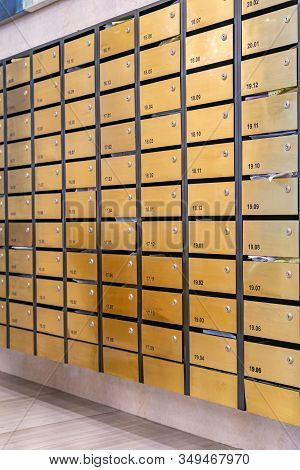 Vertical Photo Of Metallic Mailboxes In Condominium Lobby