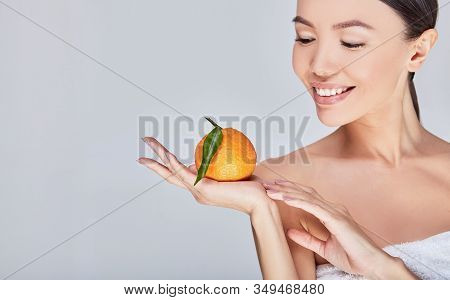 Beauty. Smiling Woman With Radiant Face Skin And Orange Portrait. Beautiful Smiling Asian Girl Model