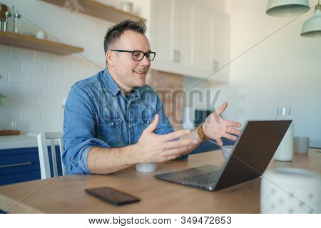 Happy Adult Man Having A Video Call With A Laptop At Home