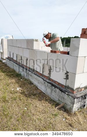 Laying The Wall Of Gas Blocks With Tools And Glue.