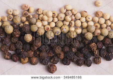 Black And White Penja Pepper (piper Nigrum) Blended With A Pepper From Madagascar Displayed On Kraft