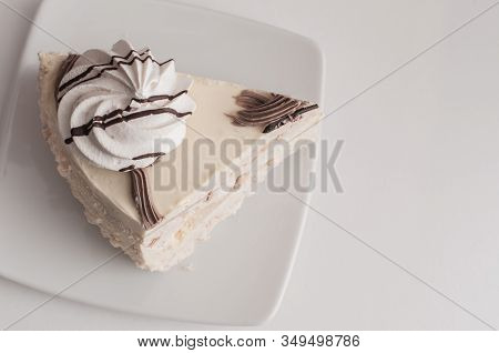 White Cake With Merinques And Cream On The Table