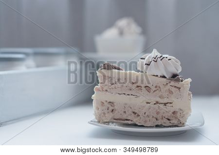 White Cake With Merinques And Cream On The Table