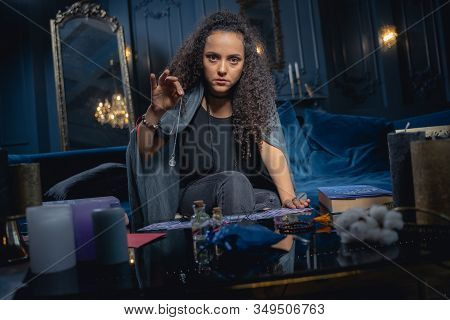 Soothsayer Holding A Crystal Pendulum In Her Hand