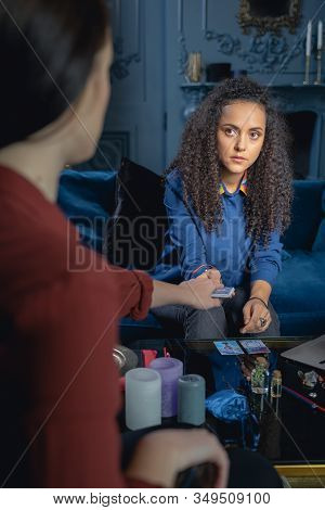 Soothsayer Holding Divination Cards In Front Of Her Client