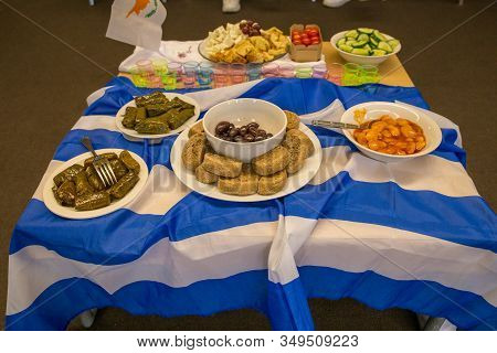 Table With Greek Food And The Greek Flag Dolmades Olives Feta