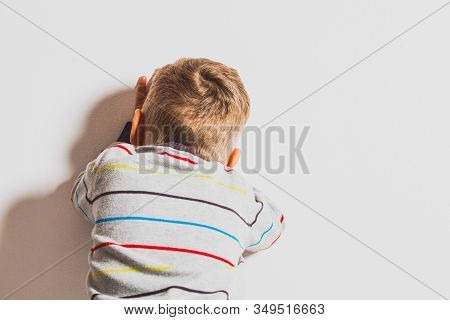 Frustrated Little 2 Years Boy Crying Near The Wall