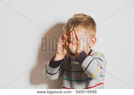 Frustrated Little Boy Crying And Covering His Face