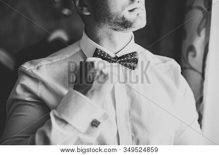Grooms Morning Preparation. Handsome Man Getting Dressed And Preparing For The Wedding