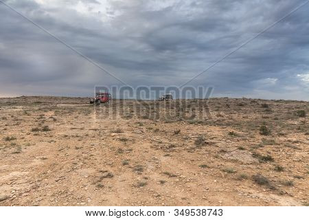 The Ustyurt Plateau. Tourists Travel By Car. District Of Boszhir. The Bottom Of A Dry Ocean Tethys. 