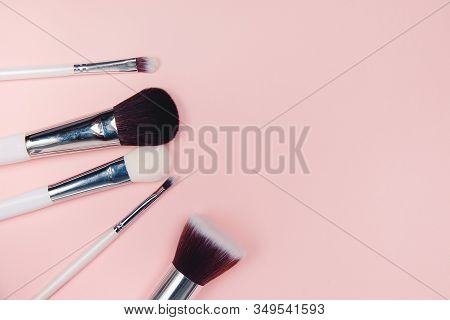 Set Kit Makeup Brushes On Pink Background, Copy Space