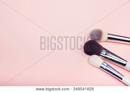 Set Kit Makeup Brushes On Pink Background, Copy Space