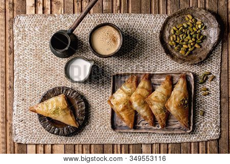 Homemade Turkish Traditional Dessert Baklava With Pistachio Served On Ceramic Plate With Bowl Of Nut