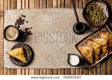 Homemade Turkish Traditional Dessert Baklava With Pistachio Served On Ceramic Plate With Bowl Of Nut