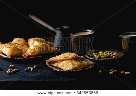 Homemade Turkish Traditional Dessert Baklava With Pistachio Served On Ceramic Plate With Bowl Of Nut