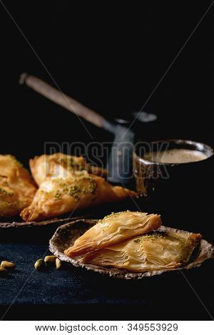 Homemade Turkish Traditional Dessert Baklava With Pistachio Served On Ceramic Plate With Bowl Of Nut