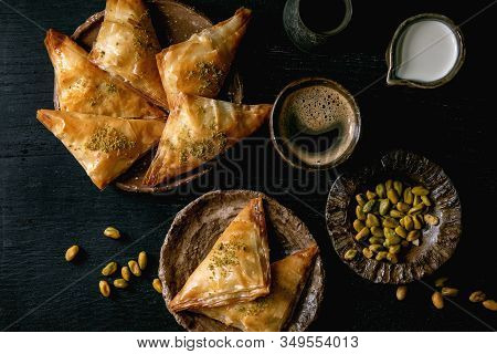 Homemade Turkish Traditional Dessert Baklava With Pistachio Served On Ceramic Plate With Bowl Of Nut