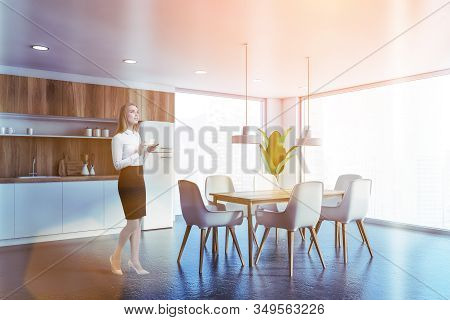 Woman In White And Wooden Kitchen With Table