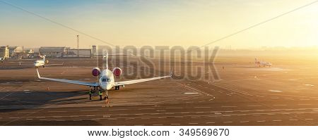 Colorful Scenic Dramatic Morning Sunset At Airport Asphalt Taxiway And Parking With Different Commer