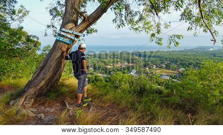 Labuan,malaysia-feb 1,2020:a Hiking Man Is Standing On The Top Of Hill And Looking To The Landscape 