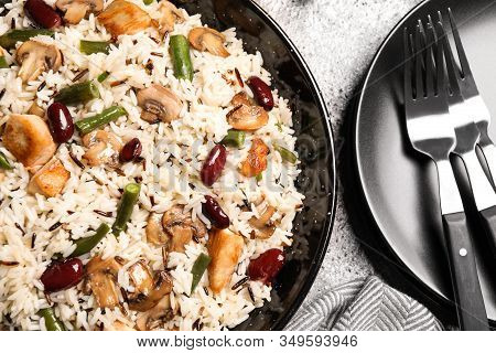 Delicious Rice Pilaf With Chicken And Vegetables On Grey Table, Closeup