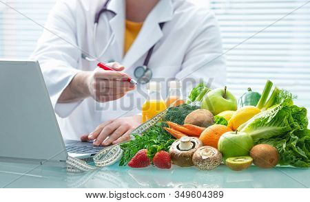 Nutritionist is consulting on healthy eating with fruits and vegetables. Nutrition and diet concept