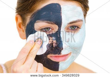 Woman With Clay Carbo Black Mask On One Half Face And White Mud On Second Half. Girl Removing Cosmet
